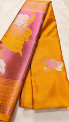 Golden yellow silk saree with pink floral and leaf motifs, traditional woven border details.