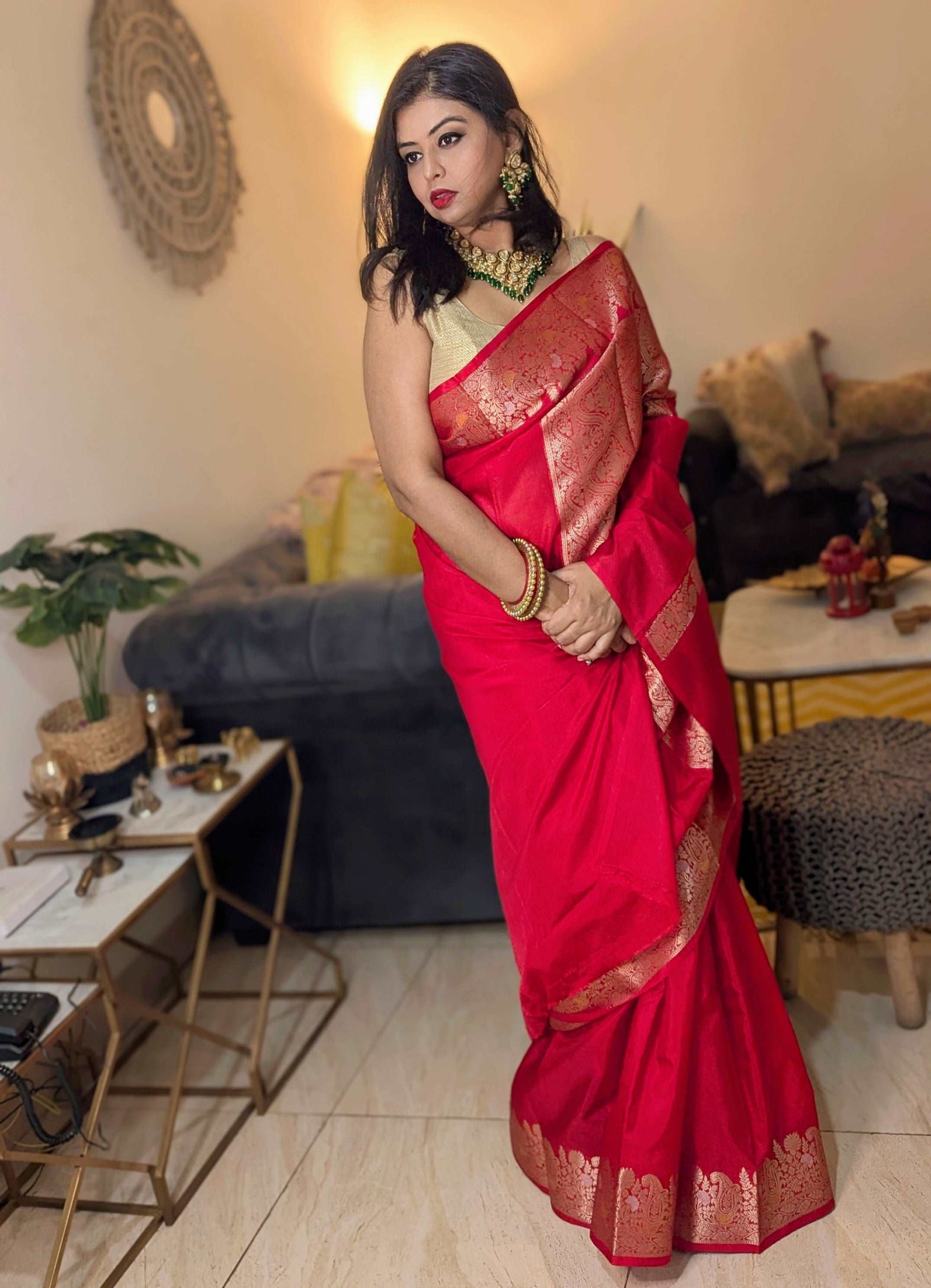 Crimson red Banarasi Chiniya silk saree with gold zari border, styled with traditional jewelry.