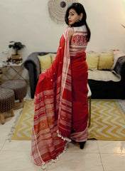 Red Bhujodi Bengal handloom saree with white geometric patterns and striped pallu, worn by a woman.