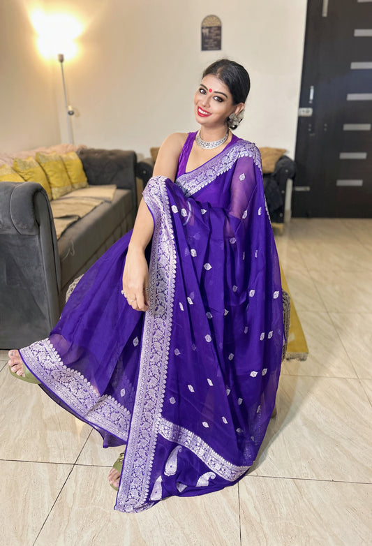Purple handloom chiffon Khaddi saree with silver embroidered border and scattered floral motifs worn with matching blouse.