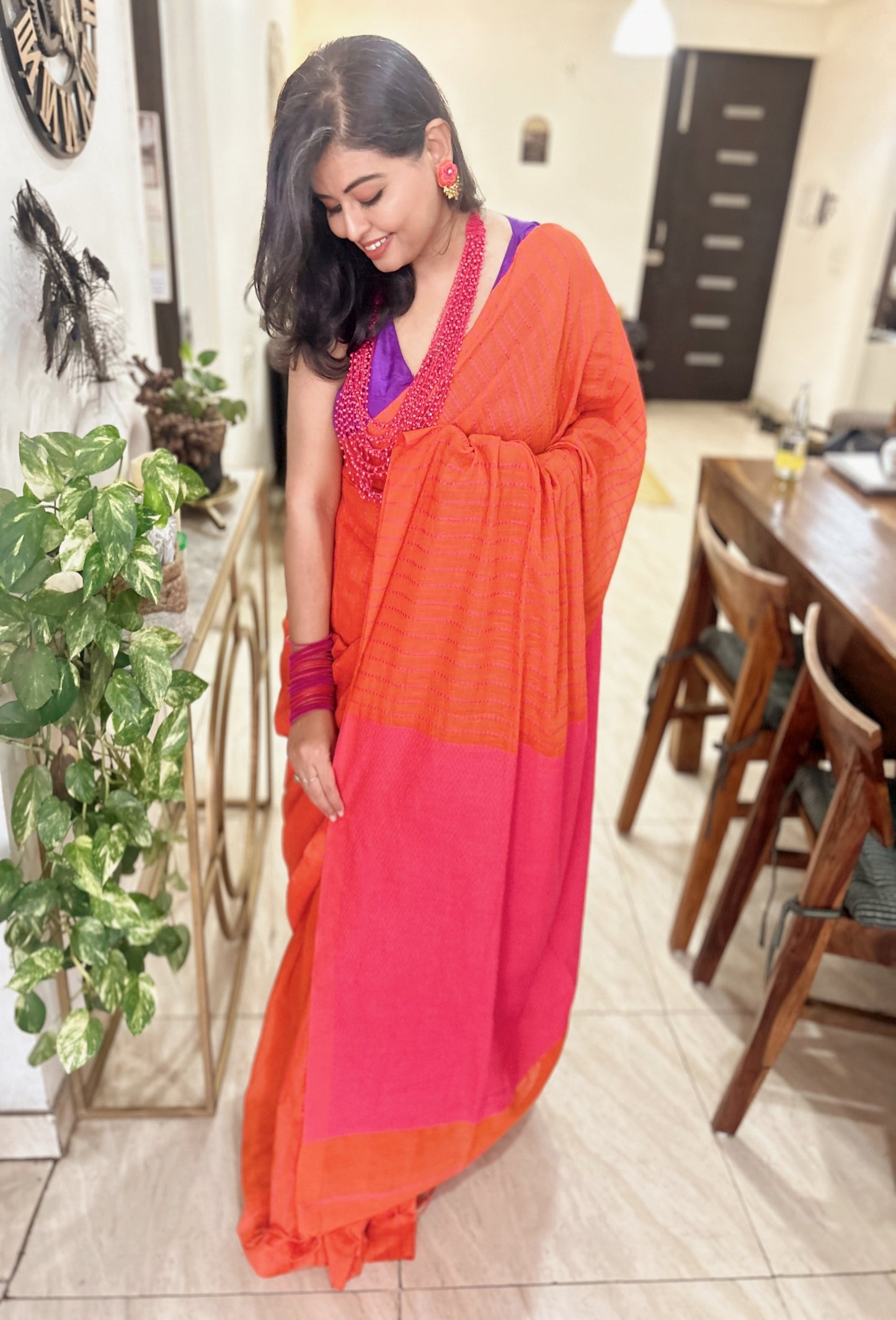 Orange and pink pure handloom cotton saree with subtle geometric Kantha stitch patterns and a contrasting border.