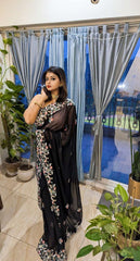 Black georgette saree with intricate floral embroidery and sheer fabric, styled with matching blouse.