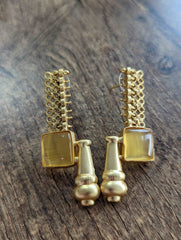 Golden brass earrings with mustard yellow Monalisa stone and dangling bead accents.