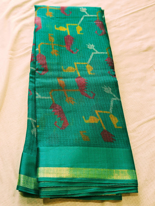 Green Kota silk saree with gold border and multicolored geometric motifs.