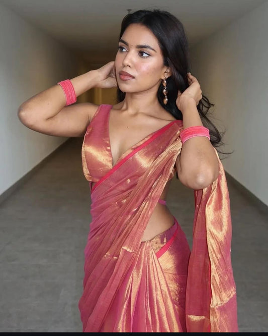 Orange and maroon dual-tone cotton silk saree with subtle sheen and traditional drape.