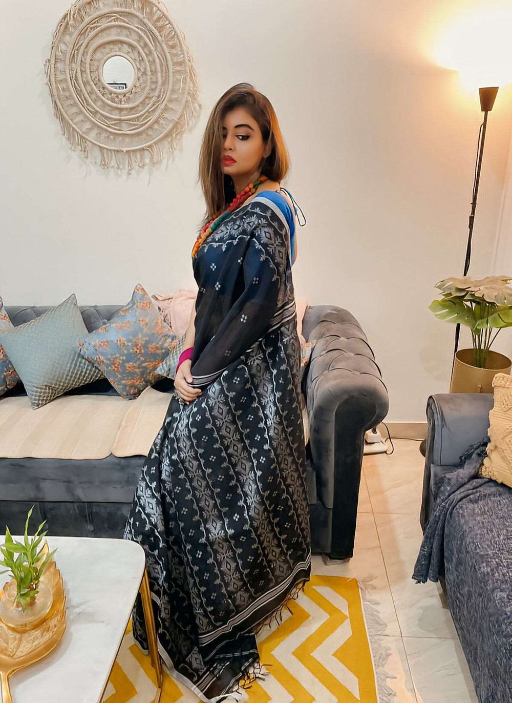 Black and white Bengal Dhakai Jamdani saree with intricate geometric patterns draped on model.