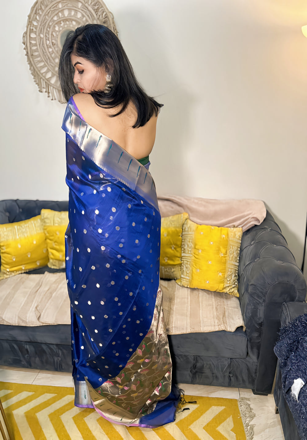 Royal blue silk Paithani saree with silver border and gold motifs, worn with matching blouse.