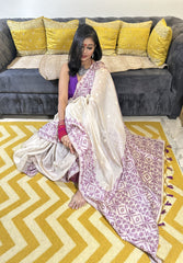 Cream and lavender Jamdani saree with geometric border and intricate floral motifs, styled with matching blouse.