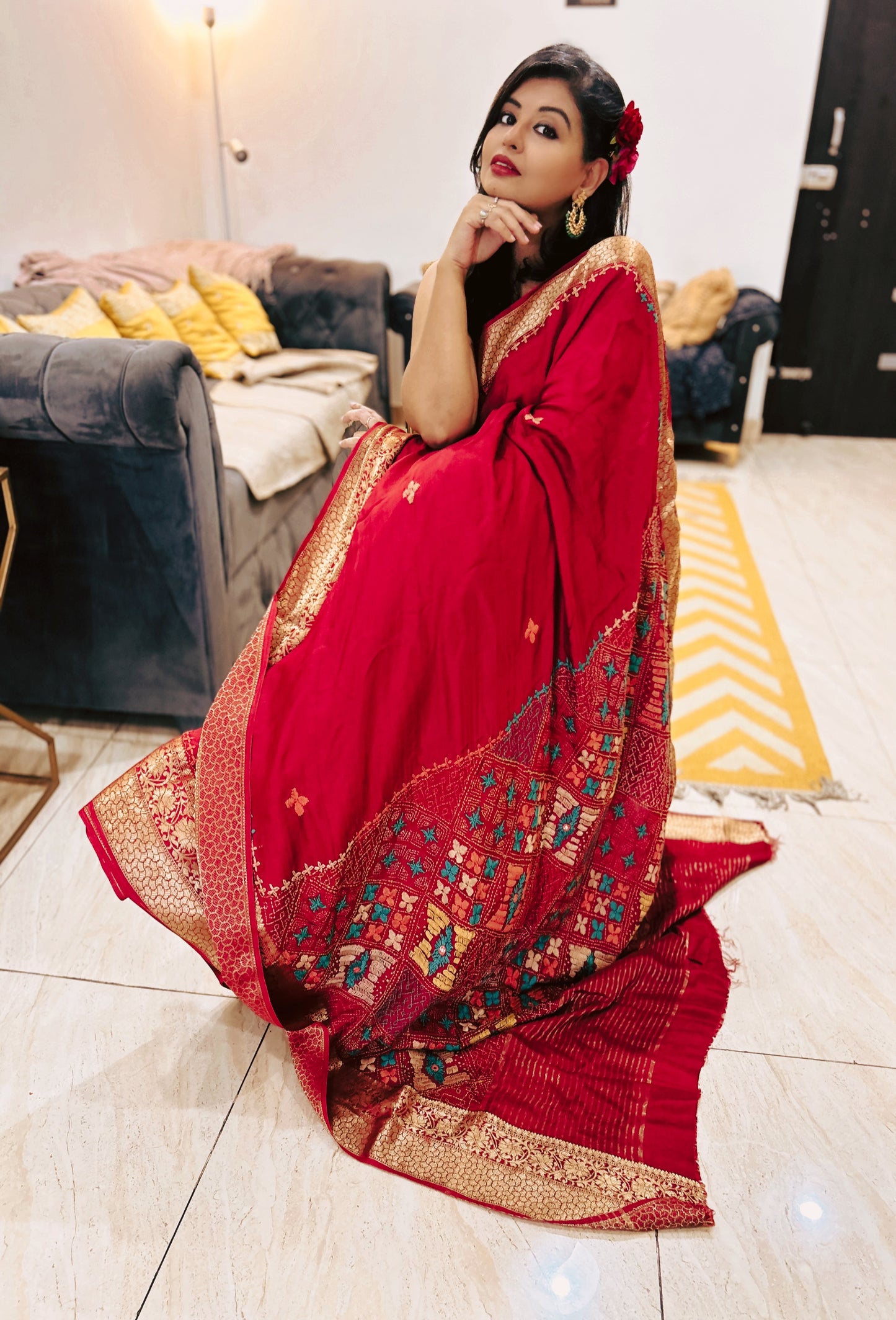 Deep blood red Pure Dola Silk Lambani saree with intricate multicolor geometric border and gold detailing.