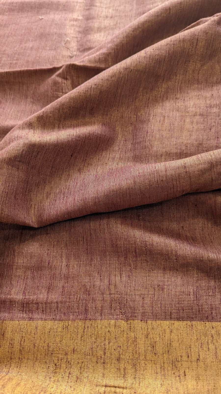 Mauve jute linen fabric with textured weave and contrasting golden border.