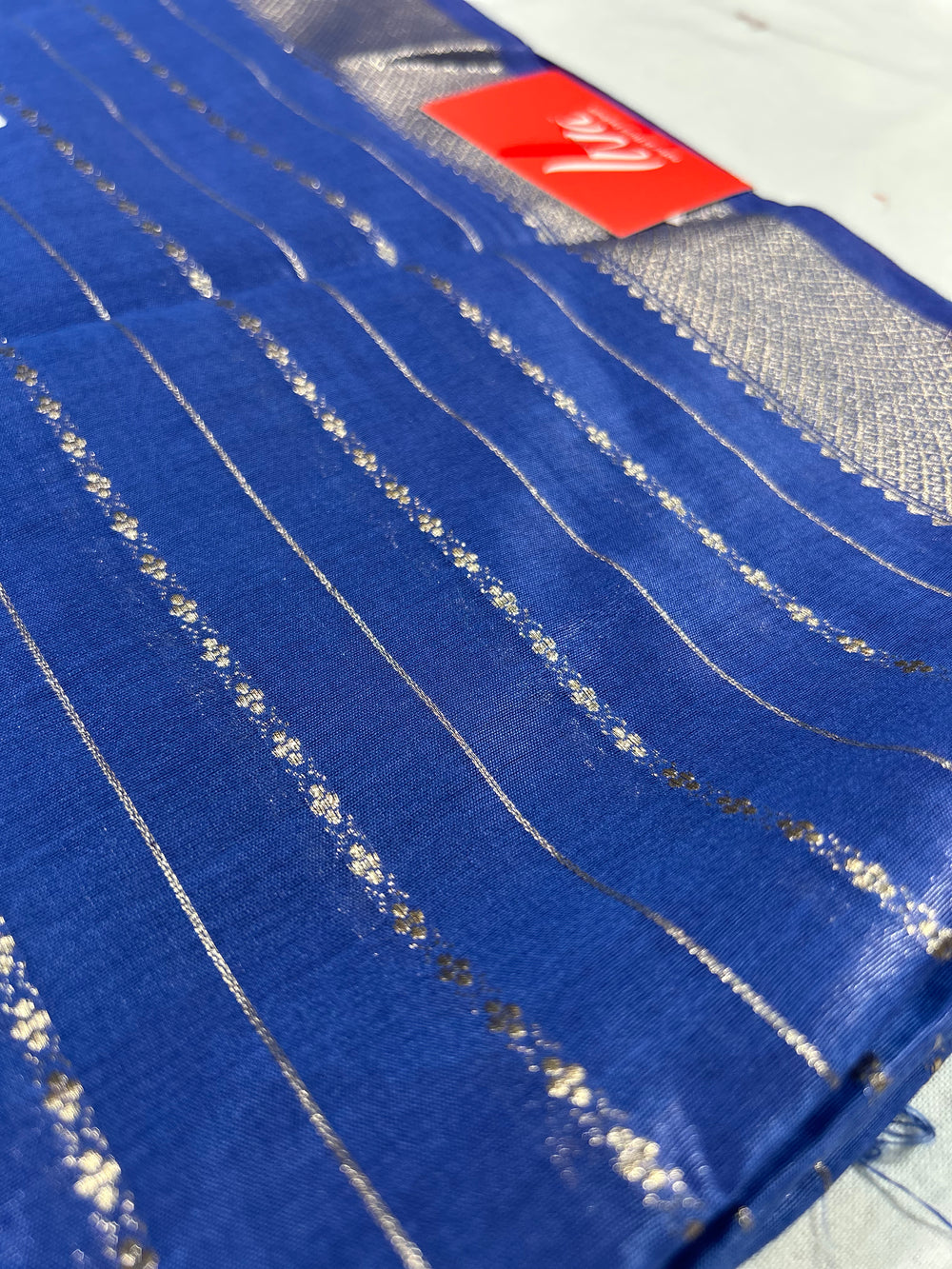 Blue Maheshwari LIVA saree with silver stripes and subtle sheen on cotton silk fabric.