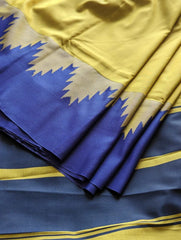 Lime green silk saree with navy blue zigzag border and gold accents.